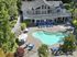 Canyon Springs apartment complex aerial view of heated outdoor pool surrounded by lush greenery and lounge chairs in Lynnwood WA