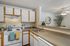 Canyon Springs renovated apartment kitchen with white cabinetry and contemporary finishes in Lynnwood WA