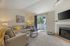 Canyon Springs apartment living room with plush sofa and large sliding glass doors to outdoor views in Lynnwood WA