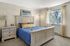 Canyon Springs apartment bedroom with cozy blue bedspread and large window with scenic views in Lynnwood WA
