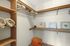 Canyon Springs spacious apartment walk-in closet with built-in wooden shelving and ample storage in Lynnwood Washington