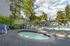 Canyon Springs resort-style pool deck with relaxing lounge chairs and vibrant greenery in Lynnwood WA
