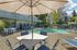 Canyon Springs heated outdoor pool with lounge chairs shaded tables and lush greenery in Lynnwood Washington