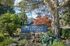 Canyon Springs community entrance surrounded by lush mature trees and beautiful landscaping in Lynnwood WA
