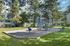 Canyon Springs children's play area nestled among mature trees perfect for family living in Lynnwood WA