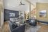 Canyon Springs double lounge with high ceilings kitchen island and large windows for resident gatherings in Lynnwood Washington