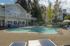 Canyon Springs outdoor pool area with surrounding lounge chairs and modern building architecture in Lynnwood WA