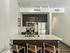 Republic on Main kitchen with sleek stainless steel appliances, elegant dark wood cabinetry, and a polished island with stylish seating in Moscow, ID