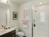 Republic on Main apartment bathroom with sleek design featuring a glass-enclosed shower, elegant vanity, and tasteful wall art in Moscow, ID