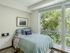 Republic on Main bedroom with modern decor and large window offering lush green views in Moscow, ID