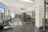 303 Flats student apartment gym with free weights and floor-to-ceiling windows overlooking Knoxville Tennessee