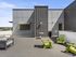 Republic on Main rooftop terrace with modern gray seating and vibrant green chairs, perfect for outdoor relaxation and entertainment under the clear blue sky in Moscow, ID