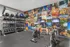 State-of-the-art fitness center with free weights and vibrant mural at The Landings apartments Knoxville TN