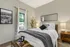 Comfortable model bedroom with plush bedding and large window at The Landings apartments Knoxville TN