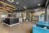Modern lobby area featuring stylish geometric front desk, vibrant blue seating, and contemporary lighting fixtures, perfect for a welcoming atmosphere.