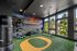 Vibrant home gym featuring a football-themed mural, lush views, and state-of-the-art fitness equipment.