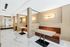 A marble-floored room with three alcoves along the wall, each containing a desk and an upholstered booth seat with outlets.