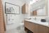 Bathroom with maple cabinets and a white marble countertop.