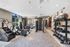 Indoor gym with weight machines, treadmills, ellipticals, stationary bikes, benches, medicine balls and large windows.