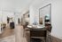 Spacious studio apartment dining area with four chairs.