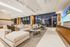 Resident lounge with plentiful seating and working areas, TV and cityscape views