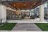 Covered poolside veranda with outdoor kitchen, bar, and television