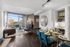 Large dining space with glass table and 6 dining chairs, with built-in desk and wide-plank wood-style flooring overlooking the living room and floor-to-ceiling windows
