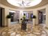 A rotunda with a geometric inlaid pattern in the stone floor and a star-shaped light fixture.