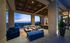 Outdoor lounge with skyline views, gray and blue couch and table area.