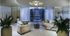 A wide lobby space with two curved, upholstered couches, a star-shaped light fixture, and floor-to-ceiling windows with drawn curtains.