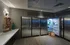 Multiple stainless refrigerators with touchscreen locks along the wall of a room with a marble counter