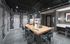 Studio with built-in and freestanding desks, art supplies, 6 closets, a sink, and black-and-white graphical letters printed on the walls