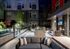 Outdoor entertainment area with a grill, 6-person dining table, fireplace, flat-screen TV, and seating area with a couch.