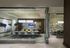 Two glass-walled conference rooms, one with a 10-person table, leather rolling office chairs, and HD presentation TV.