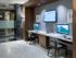 Two workstations in the E-lounge with Mac computers and an additional 60-inch presentation monitor.