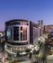 Aerial view of Hanover Northgate mid-rise building located at the sharp intersection of two busy streets. The building has a black and silver exterior and trees and landscaping lining the sidewalk.