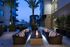 Alternate view of the outdoor firepit and seating area showing the stone material of the modern rectangular firepit.