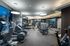 Treadmills, ellipticals, stair climbers, and weight machines in the gym.