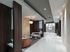 Seating area with two loveseats tucked in a quiet nook. There is wood paneling on the walls and marble tile on the floors.