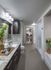 Bathroom with a frameless glass walk-in shower, dual vanity with a granite countertop, and an attached walk-in closet.