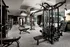 Indoor gym with weight machines, treadmills, a stair machine and benches.