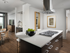Kitchen island with dark wood cabinetry, a gas stove with a vent hood, a white quartz countertop and two tall barstools. The room opens to a dining area with a dry bar, and there is modern artwork framed on the walls.