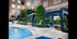 Two blue fabric poolside cabanas in a landscaped courtyard with two blue lounge chairs each.