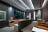 Private theater with a large projector screen and two tiered rows of large leather armchairs