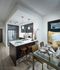 Open-concept kitchen and dining area with a 4-person dining table, dark wood cabinets, stainless appliances, and a quartz-topped peninsula