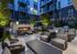 Expansive courtyard featuring conversational seating areas, fire features, and dining & grilling areas