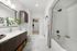 bathroom with white countertops, linen closet and soaking tub