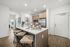 kitchen island with white quartz countertop and 3 counter stools