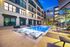 Resort-style pool with Sunbrellas and in-pool chaises