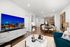 apartment living room with large tv, sofa and dining room